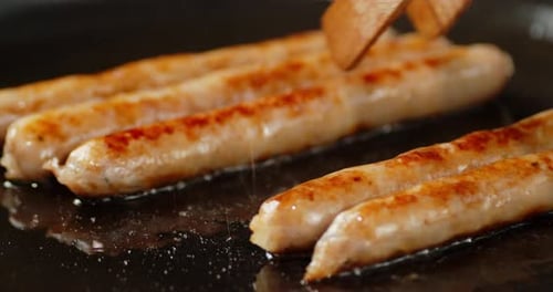 Sausages Cooking on a Flat Top Grill
