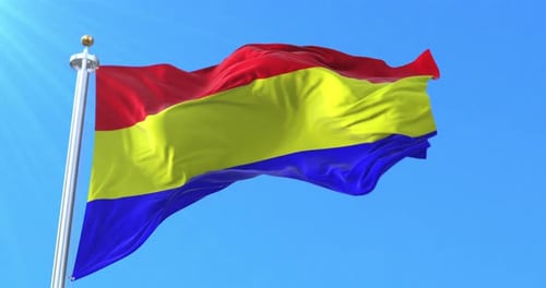 Red Yellow Blue Striped Flag Waving in Blue Sky