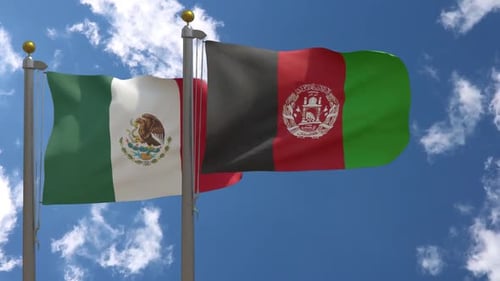 Mexico and Afghanistan National Flags Waving Against Blue Sky