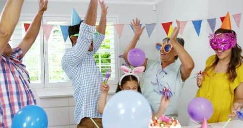 Family Celebrates Birthday with Balloons and Cake