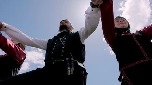 Three People Holding Hands in a Sunny Field