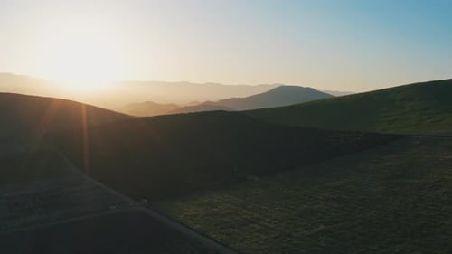 Golden Hour Over Rolling Green Hills Landscape