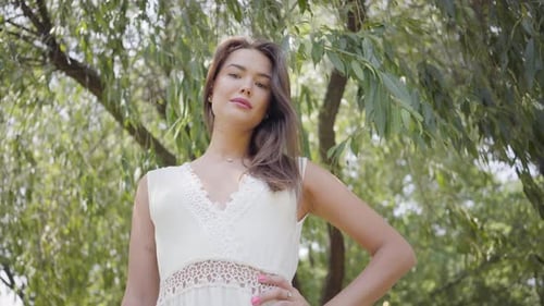 Elegant Woman Posing in Nature on Sunny Day