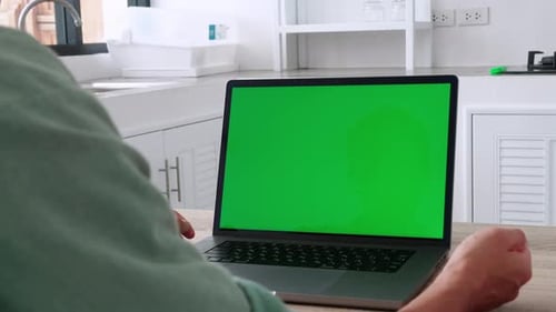 Closeup Back View Shoot of Young Business Man Having a Video Call on the Laptop with Green Chroma