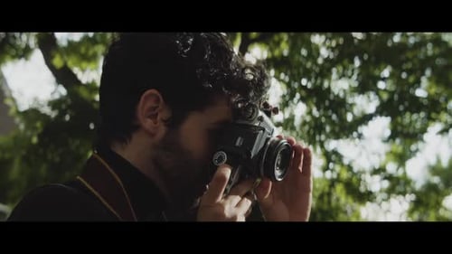 Caucasian man taking pictures in a park