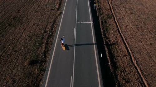 Aerial Dolly Drone Shot of One Man Ride Longboard