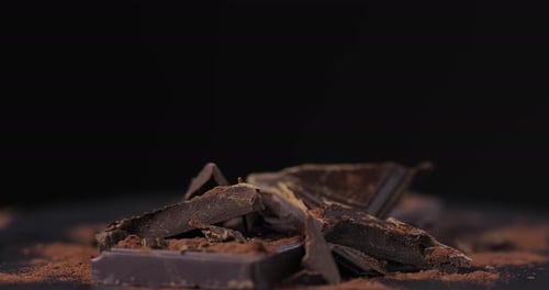 Delicious Dark Chocolate Pieces with Cocoa Powder, Close-Up