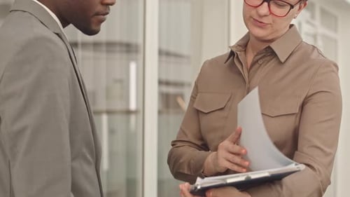 Business Professionals Conclude Meeting with Handshake in Office