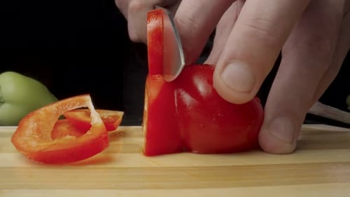 Close Up Cutting Red Bell Pepper on Wood