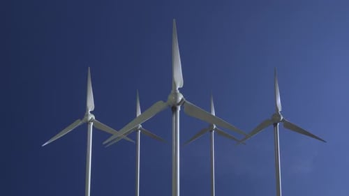 Row of Wind Power Generators on Blue Sky Background