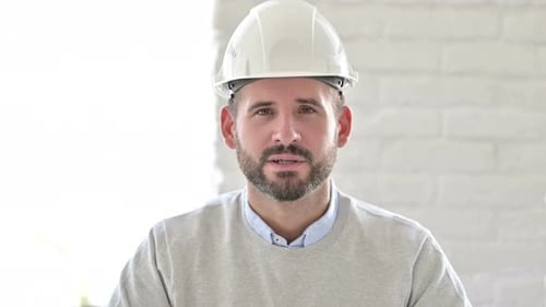 Man in Hardhat Talking and Gesturing