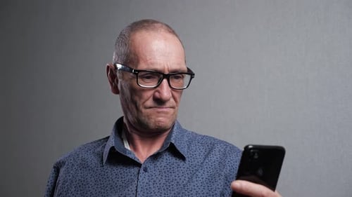 Adult Man Looking at Smartphone Device