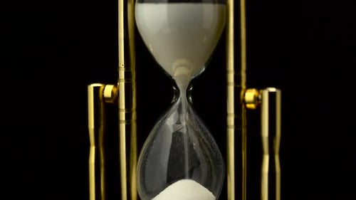 Hourglass Is Made of Glass Wooden and Sand. Black Background