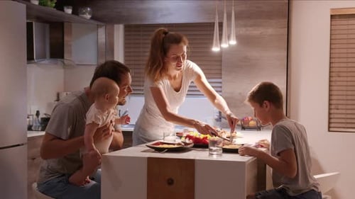 Happy Family Preparing and Eating Meal Together