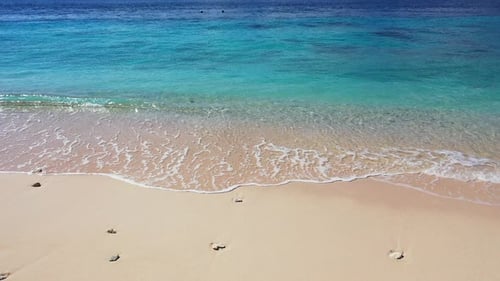 Beautiful overhead tourism shot of a white sand paradise beach and aqua blue water background in bes