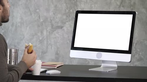 Busy Businessman Having Late Lunch Eating Sandwich in Office Working. White Display