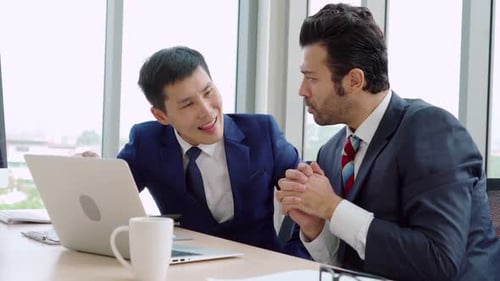 Two Business People Talk Project Strategy at Office