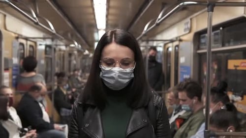 Close-up woman in the subway during the 2019-ncov corona virus pandemic.