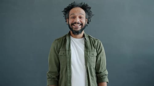 Man Smiling with Curly Hair and Beard Portrait