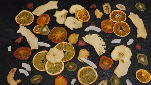 Arrangement of Dehydrated Fruit Slices on Dark Background
