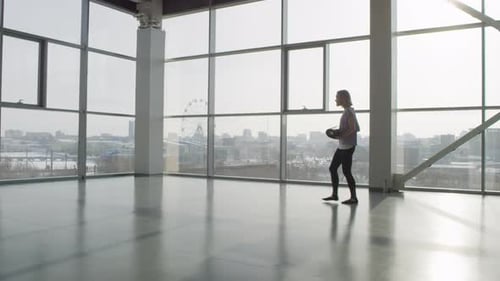 Young Woman Alone In Gym Hall