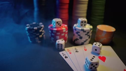 Casino Chips with Dice and Playing Cards on a Dark Table
