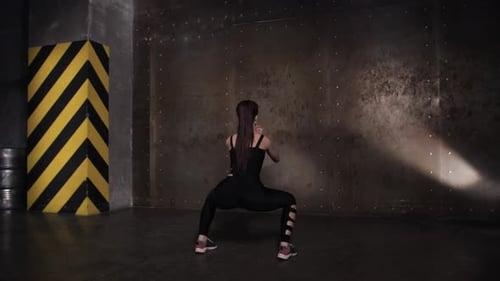 Occupation in the Gym Beautiful Sportswoman. Squats and Lunges.