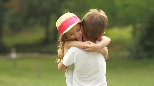 Little Boy Takes the Girl in Her Arms and They so Spin Around in the ...