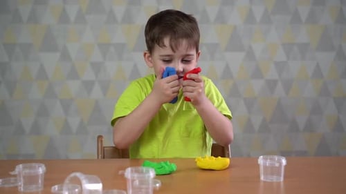 Little Boy Moulds From Plasticine on Table. Ready for School. Home Schooling. Back To School.