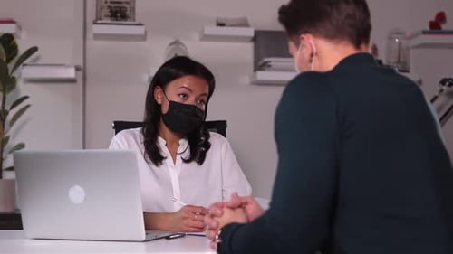 Woman Interviews Man of Job Seeker at Table with Laptop in Modern Office Spbi