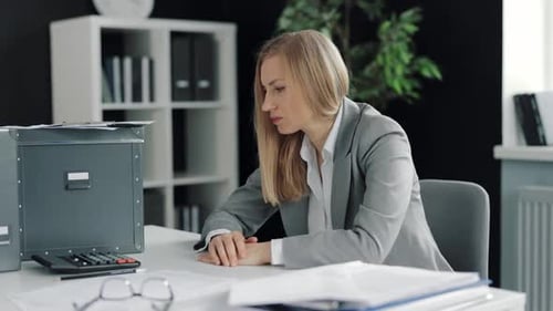 Tired Woman Resting Head at Office Desk