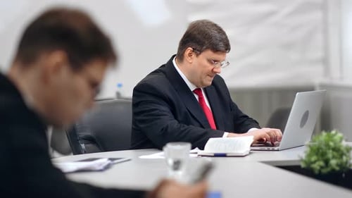 Focused Male Office Worker in Suit Working Using Laptop Typing on Keyboard