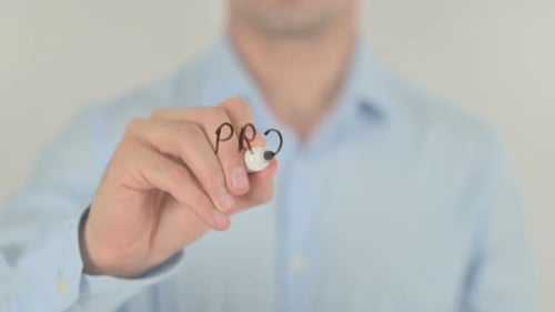 Man Writes Product Release In Front of Camera