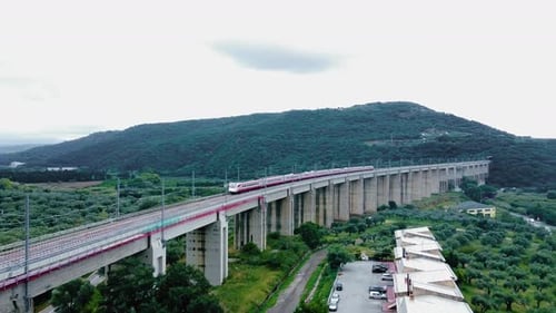 Train Traveling Across Concrete Bridge in Rural Setting