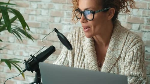 Woman Recording Podcast in Front of Laptop