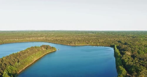 Aerial Panorama View on the Green Forest Between Turquoise Color Lake
