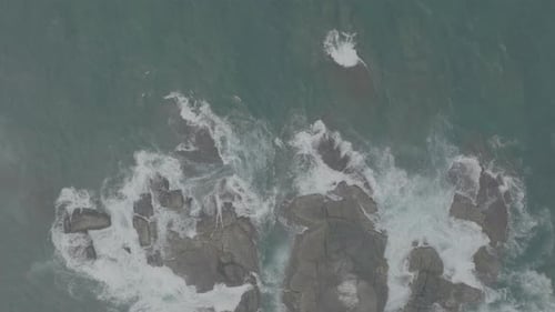 Waves Crash Against Rocks in the Ocean