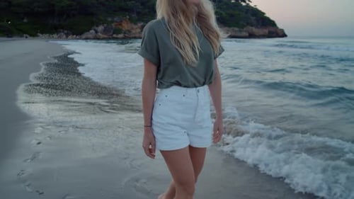 Young Woman Walk on Edge of Water at Beach