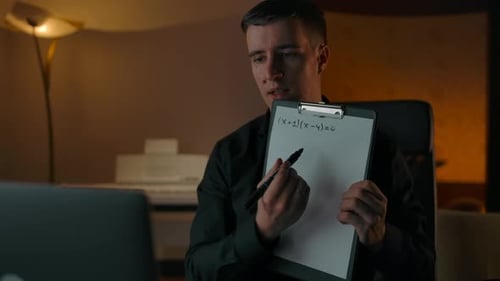 Man Teaching Math Online from Home at Night