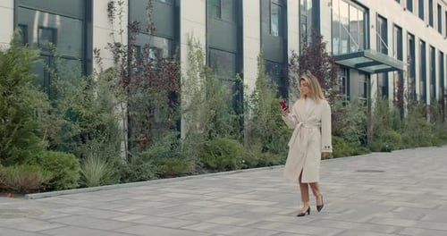 Stylish Woman Using Smartphone in Urban Environment