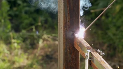 Closeup Fence Building with Using Welding Tool Under Sparks