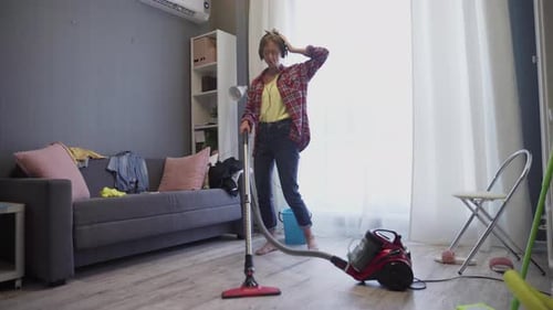 Woman Vacuuming and Dancing to Music at Home