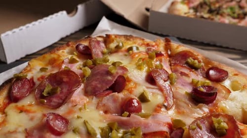 Delicious Pizza with Ham and Pepperoni in Box
