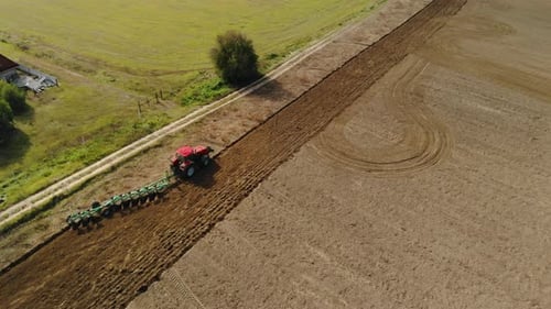 Aerial View of Tractor Plowing Field