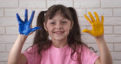 Child with Blue and Yellow Paint on Hands