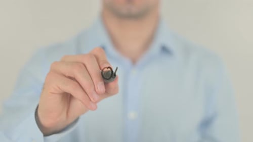 Man Writing Our Strategy on Clear Surface