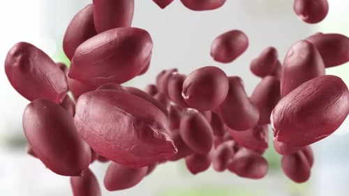 Red Shelled Peanuts Rotating in Bright Background