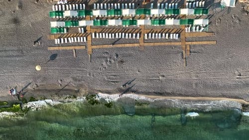 Empty sun loungers on the beach aerial view 4 K Turkey Alanya