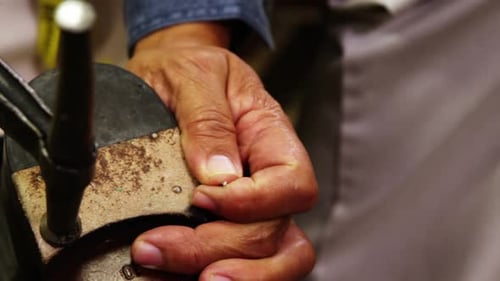 Man Attaches Metal Tap To Shoe Close Up