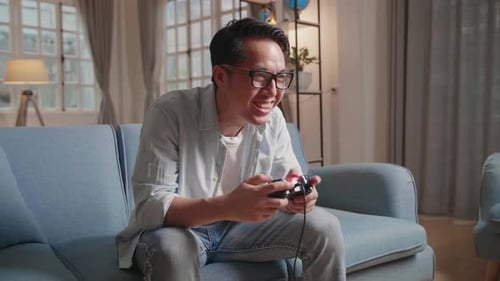 Man Enjoying Video Game on Couch Indoors